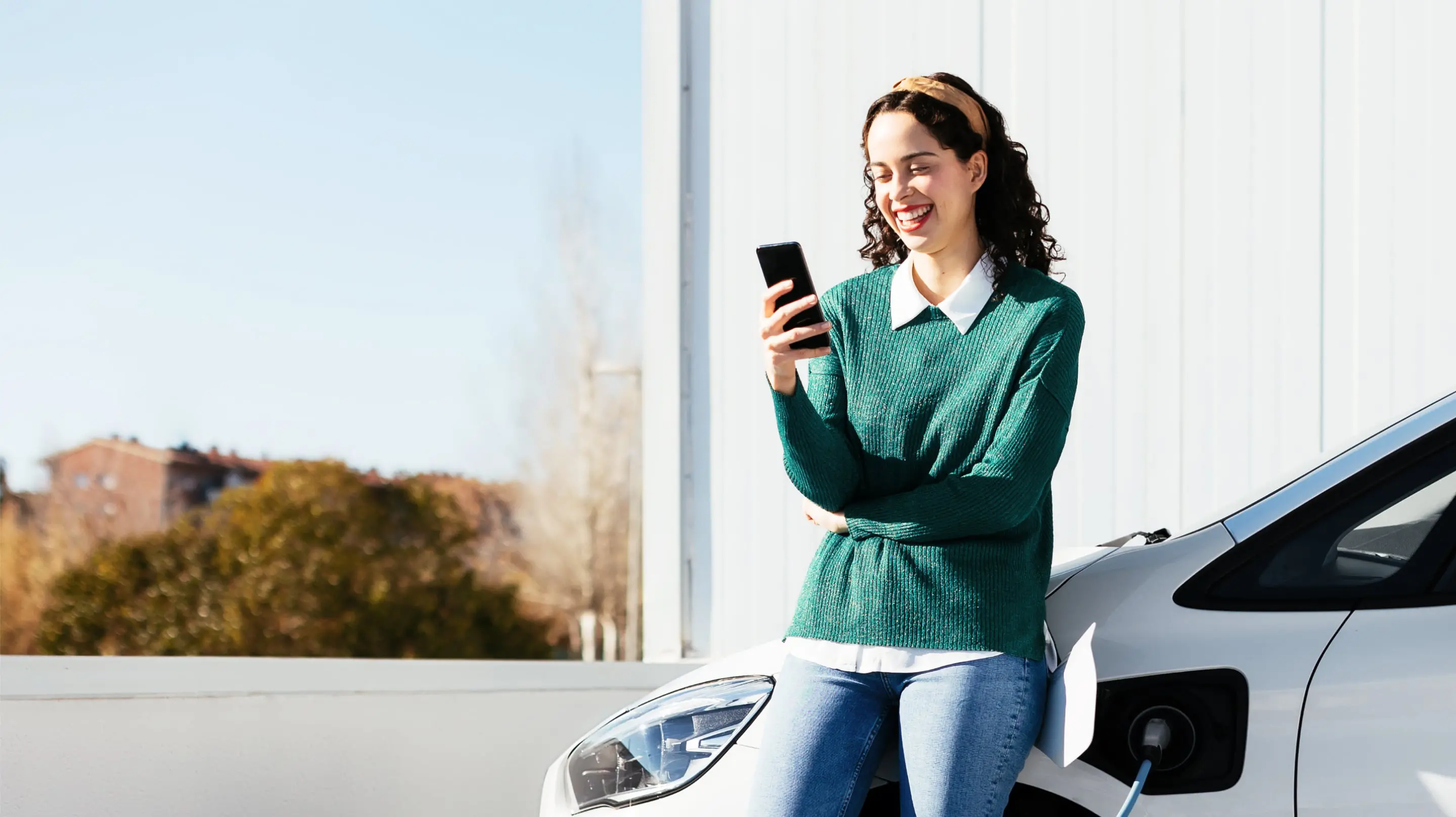 Female checking her rate for an Upstart powered personal loan while charging her car